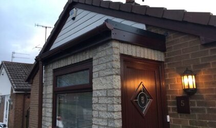 Porch with flat roof showing integrated fascia and soffit installation