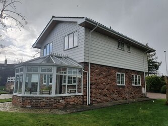 Soffit board installation providing ventilation and protection to roof overhang
