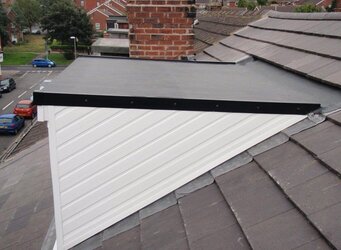 Attic conversion with dormer window featuring premium flat rubber roofing system