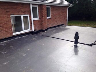 Modern flat roof extension installation with weatherproof rubber membrane