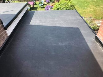 Seamless flat roof extension connecting existing property with new build