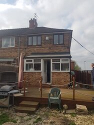 Custom lean-to flat roofing structure providing covered outdoor space