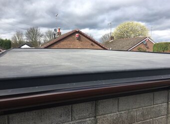 Modern garage building with high-quality flat rubber roof membrane installation