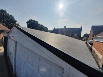 Garage with rubber pitched roof combining durability with traditional appearance