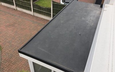 Entrance porch featuring flat rubber roof installation enhancing property appearance