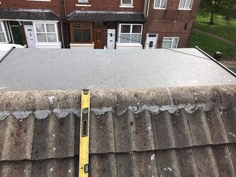 Upstairs dormer window flat roof installation with precision rubber membrane fitting